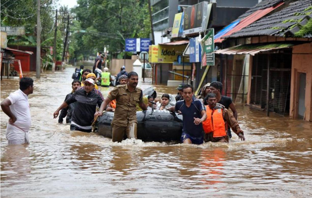 Rescuers evacuate people from a flooded area to a safer place in Aluva, Kerala after the worst monsoon rains in 100  years devastated local communities. 
August 18, 2018. REUTERS/Sivaram V . Courtesy www.alertnet.org