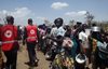 People queue for a food distribution in a refugee camp in Northern Uganda