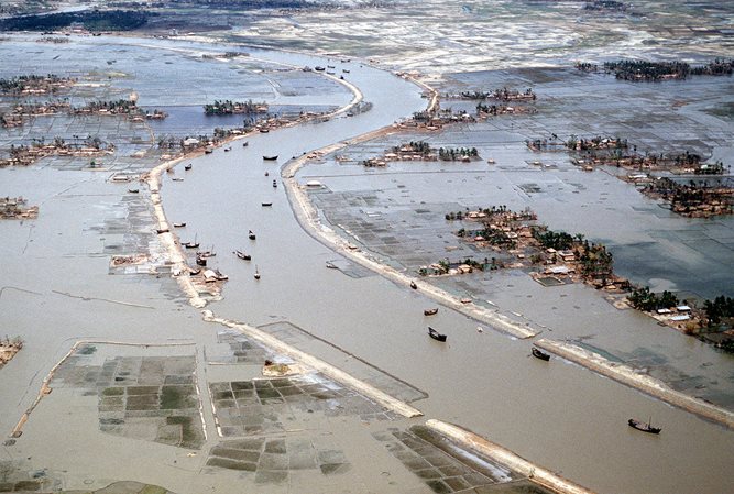Flooded villages and fields around a river in Bangladesh the day after the 1991 Bangladesh cyclone had struck the country.